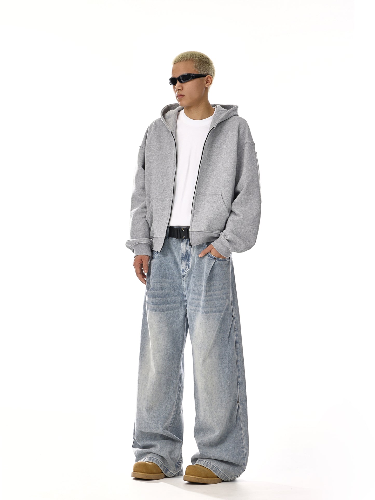 Man in streetwear style with grey hoodie, white t-shirt, baggy jeans, sunglasses, Vaezion Shop