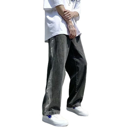Man in streetwear style with oversized white shirt, wide-leg black jeans, Vaezion Shop fashion