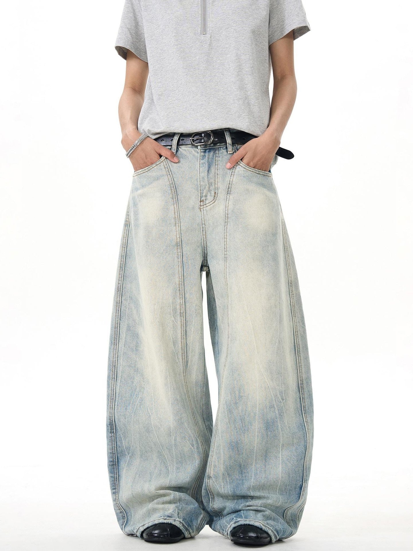 Model in light wash ultra wide leg jeans and grey short sleeve shirt, Vaezion streetwear