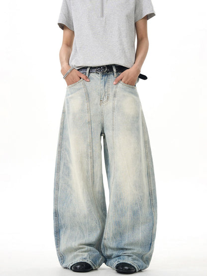 Model in light wash ultra wide leg jeans and grey short sleeve shirt, Vaezion streetwear
