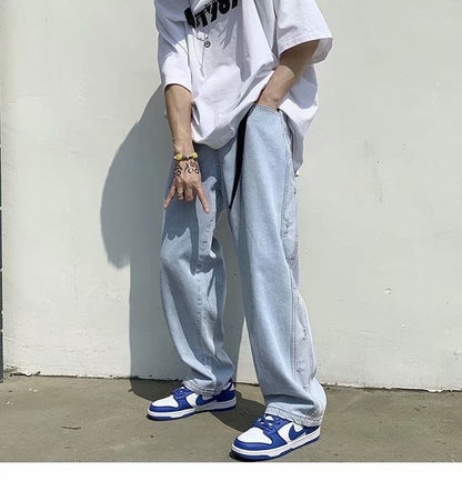 Streetwear look with oversized white t-shirt, baggy jeans, and blue Nike sneakers from Vaezion Shop