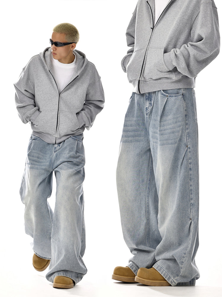 Man in oversized grey hoodie and baggy blue jeans, streetwear style, Vaezion Shop fashion