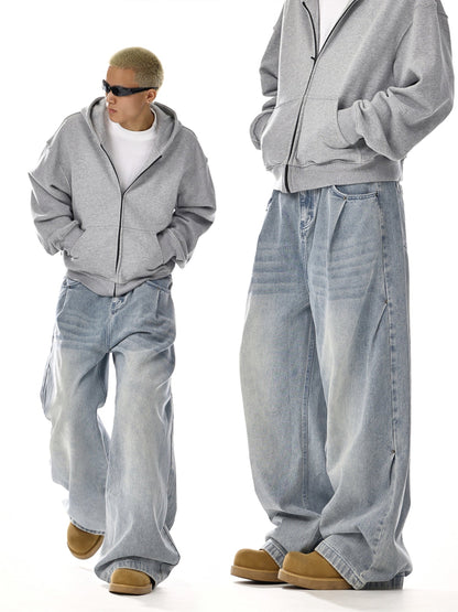 Man in oversized grey hoodie and baggy blue jeans, streetwear style, Vaezion Shop fashion