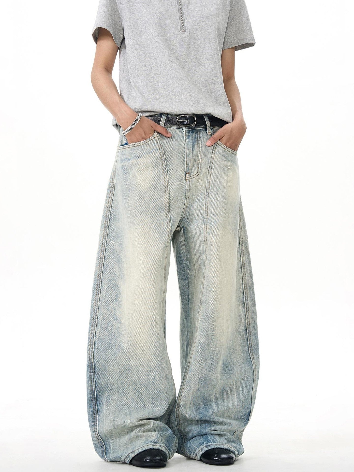 Model wearing light-wash wide-leg jeans and a grey short sleeve shirt, Vaezion streetwear